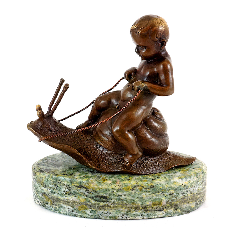 Boy Riding On Snail Statue