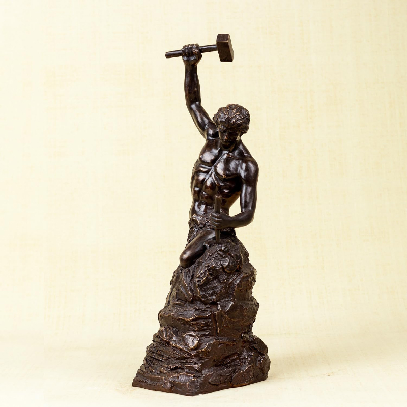 statue of man chiseling himself