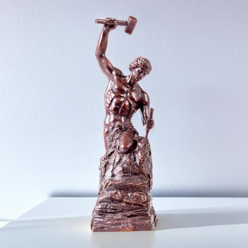 man carving himself statue