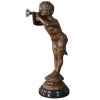 little boy playing the horn statue