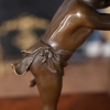 little boy play the horn statue