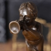 little boy play the horn sculpture